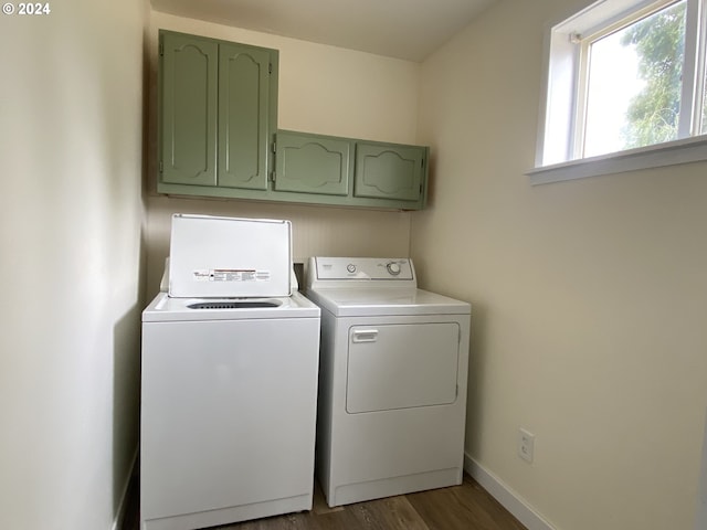 laundry room with washer and dryer, hardwood / wood-style floors, and cabinets