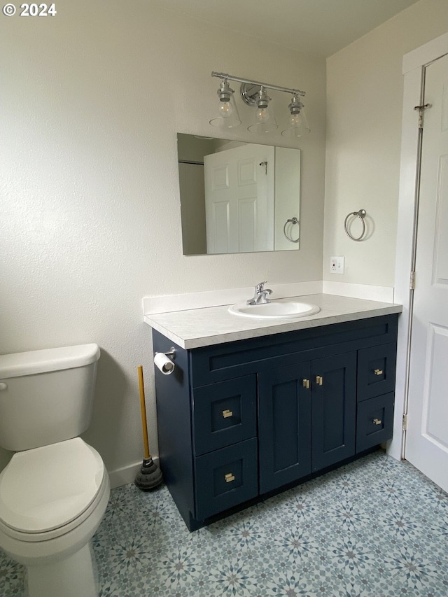 bathroom featuring tile patterned floors, vanity, and toilet