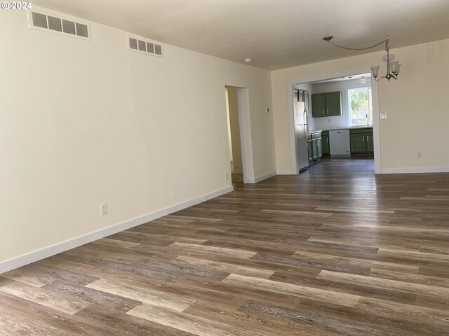 interior space with sink, a notable chandelier, and dark hardwood / wood-style flooring