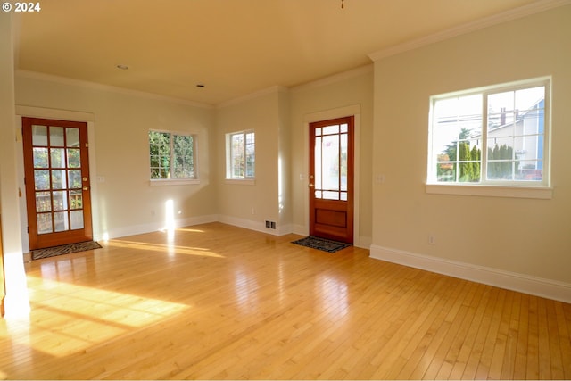 entrance foyer with light wood-type flooring and crown molding