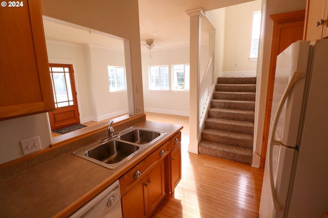 kitchen featuring white appliances, sink, light hardwood / wood-style flooring, ceiling fan, and ornamental molding