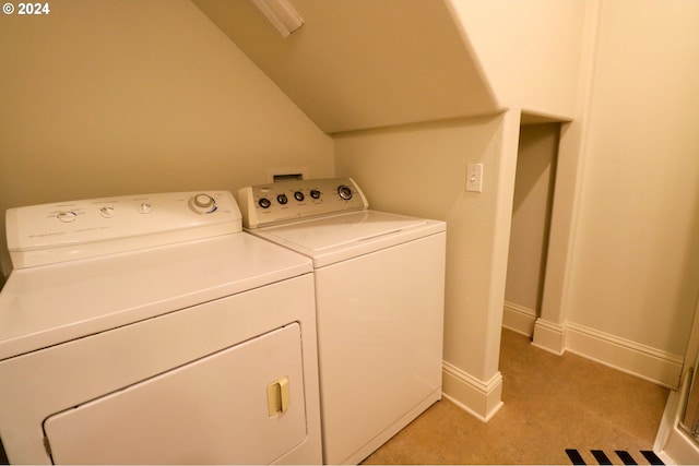 laundry area with washer and dryer and light carpet