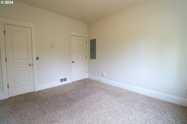 unfurnished room featuring carpet flooring and electric panel