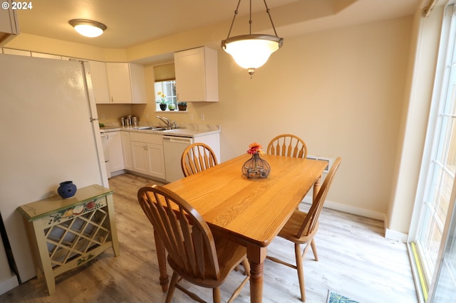 dining area featuring light hardwood / wood-style flooring and sink