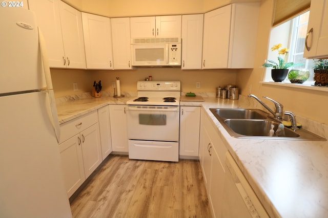 kitchen with white cabinetry, white appliances, sink, and light hardwood / wood-style flooring