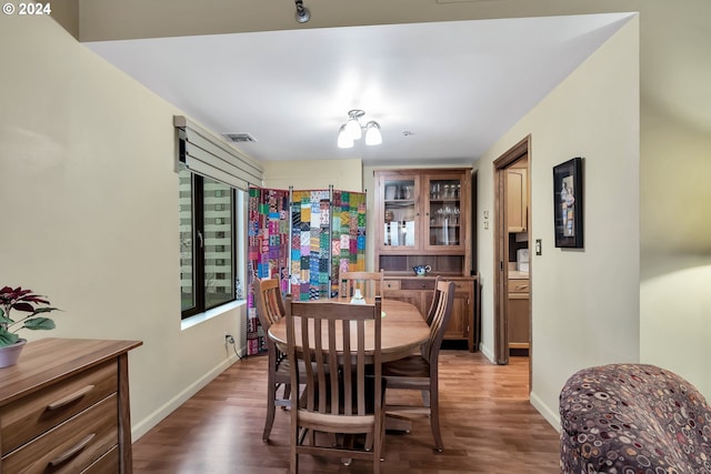 dining space with dark hardwood / wood-style flooring