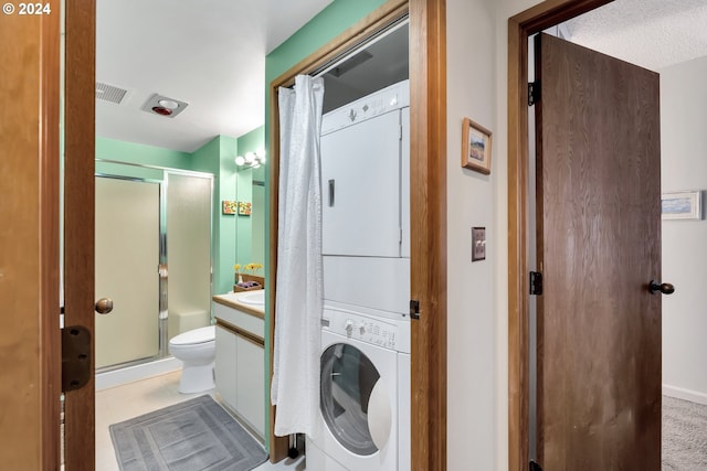 laundry room featuring stacked washer and dryer