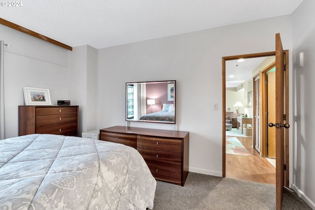 carpeted bedroom featuring a textured ceiling