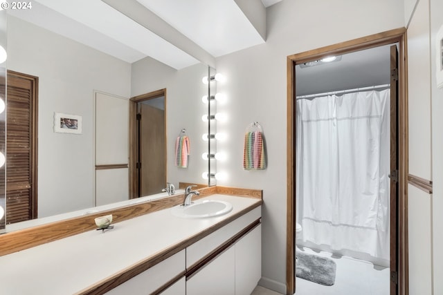 bathroom featuring tile patterned floors, vanity, and toilet