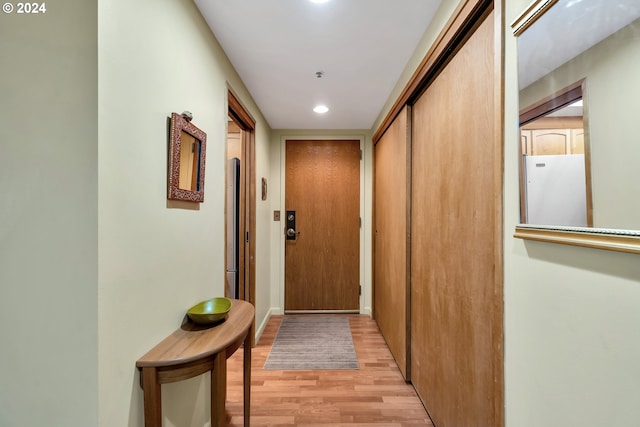 corridor with light hardwood / wood-style flooring