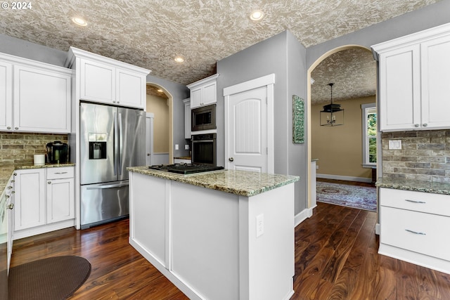 kitchen featuring a kitchen island, dark hardwood / wood-style flooring, stainless steel appliances, and white cabinets