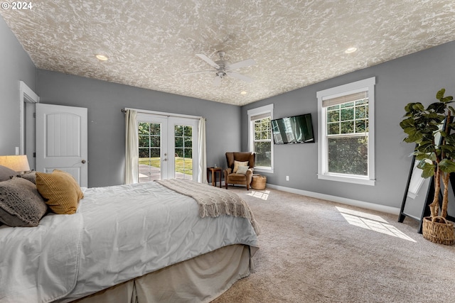 carpeted bedroom featuring ceiling fan, french doors, access to exterior, and multiple windows