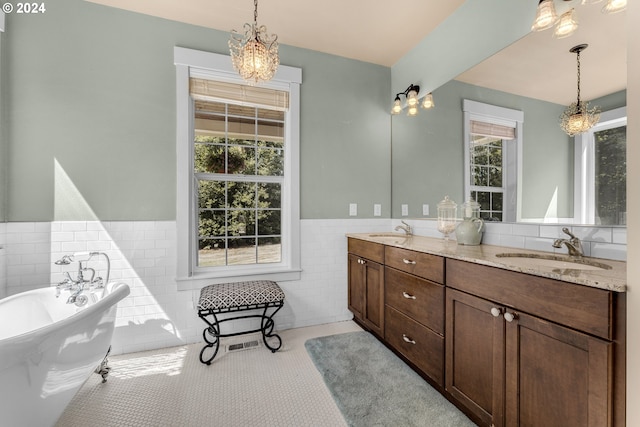 bathroom with vanity, tile walls, and a washtub