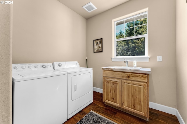 washroom with cabinets, sink, dark wood-type flooring, and washer and dryer