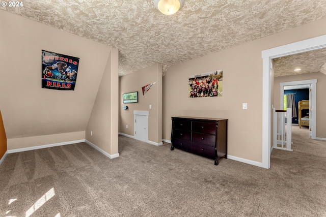 unfurnished bedroom with light carpet and a textured ceiling