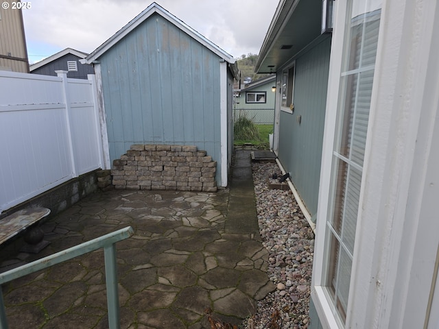 40 NW Cary St, Winston, OR 97496 - view of patio / terrace featuring an outbuilding, a storage unit, and fence