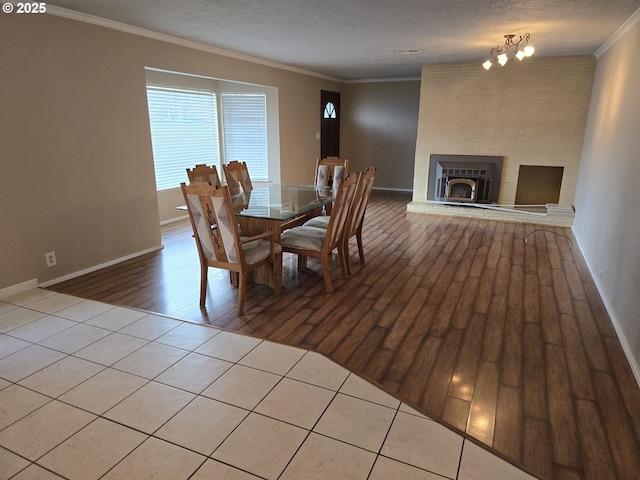 40 NW Cary St, Winston, OR 97496 - dining space with a notable chandelier, ornamental molding, a textured ceiling, wood finished floors, and baseboards