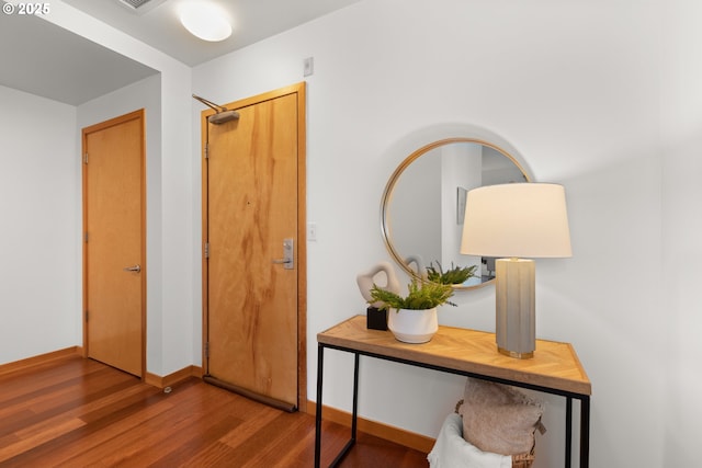 corridor featuring hardwood / wood-style floors