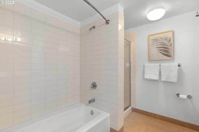 bathroom with tile patterned flooring and tiled shower / bath combo