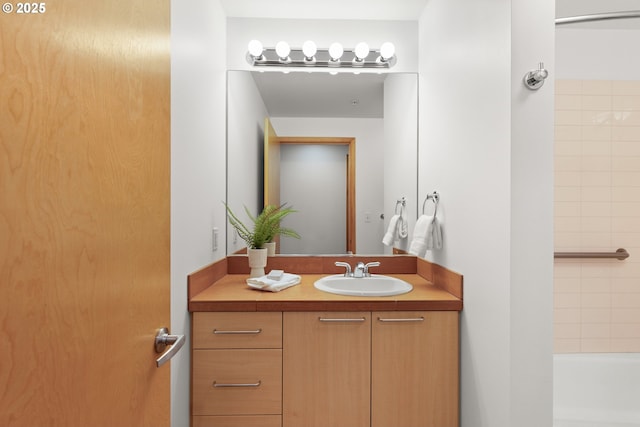 bathroom with vanity and a washtub