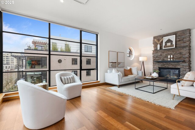 living room featuring a fireplace and wood-type flooring