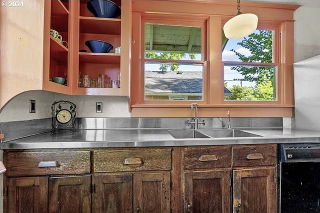 kitchen featuring stainless steel countertops, dishwasher, a sink, and healthy amount of natural light