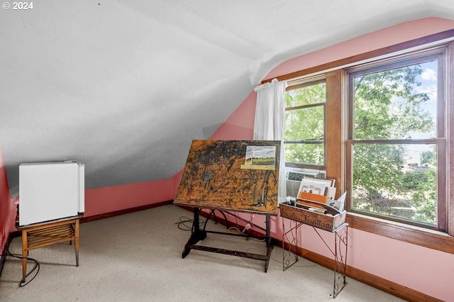 carpeted office space with lofted ceiling, baseboards, and cooling unit