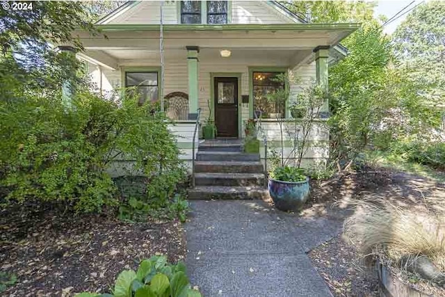 doorway to property featuring covered porch