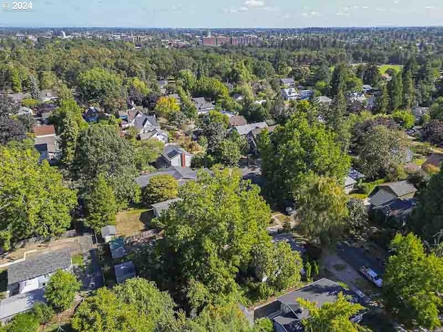 aerial overview of property's location with a heavily wooded area and nearby suburban area
