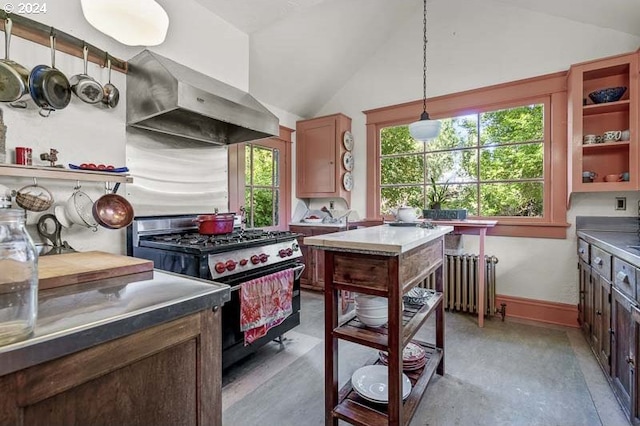 kitchen featuring gas range, wall chimney range hood, vaulted ceiling, healthy amount of natural light, and radiator