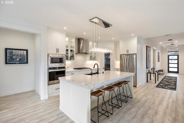 4116 S 16th Way, Ridgefield, WA 98642 - kitchen with stainless steel appliances, wall chimney range hood, a sink, baseboards, and recessed lighting