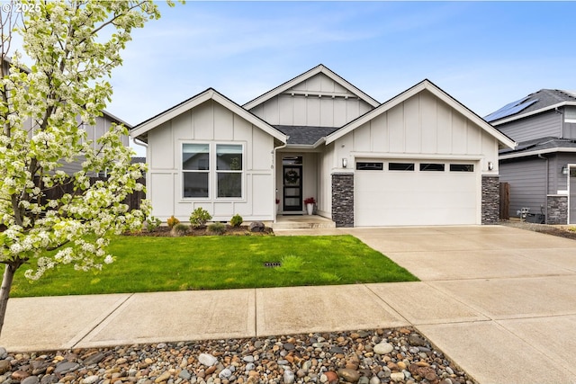 4116 S 16th Way, Ridgefield, WA 98642 - view of front of property with board and batten siding, an attached garage, concrete driveway, and a front lawn