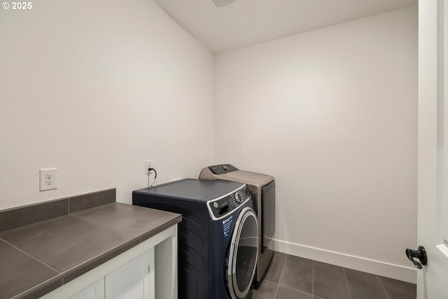 4116 S 16th Way, Ridgefield, WA 98642 - laundry room with washer and clothes dryer, dark tile patterned floors, baseboards, and cabinet space