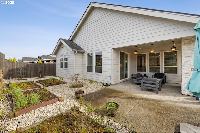 4116 S 16th Way, Ridgefield, WA 98642 - back of property featuring a vegetable garden, a patio, and an outdoor living space
