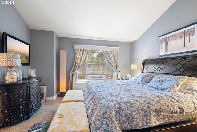 bedroom featuring light carpet and vaulted ceiling