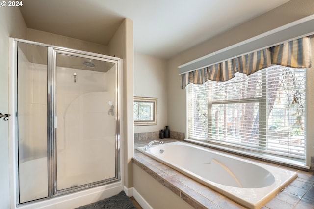 bathroom with separate shower and tub