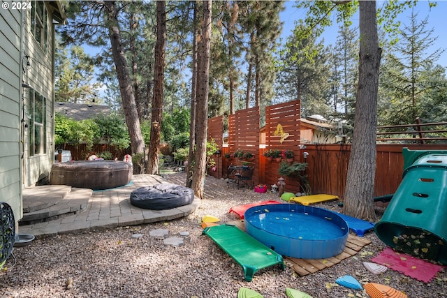 view of yard with a jacuzzi and a patio area