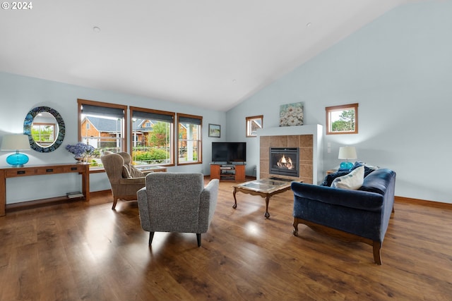 402 Diamond Ln, Gearhart, OR 97138 - living room with a tiled fireplace, baseboards, wood finished floors, and high vaulted ceiling