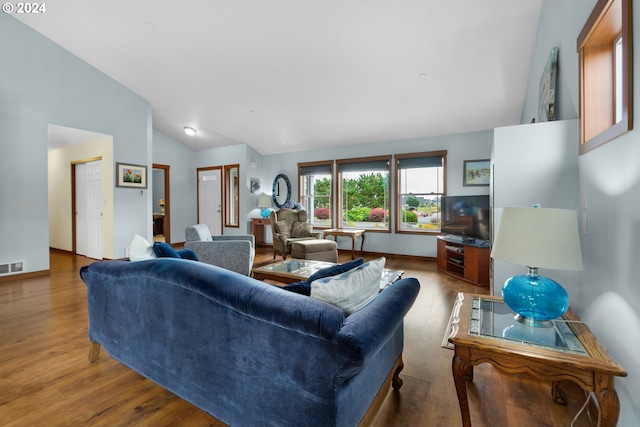 living room featuring high vaulted ceiling and light wood-type flooring