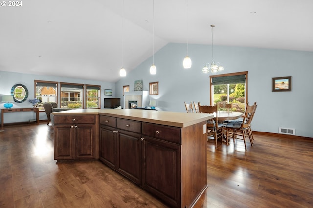 kitchen with a kitchen island, dark hardwood / wood-style floors, a chandelier, hanging light fixtures, and dark brown cabinetry