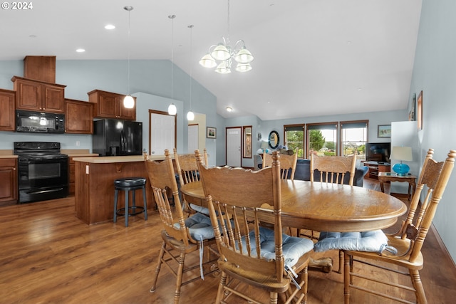 dining space with dark hardwood / wood-style floors, a notable chandelier, and high vaulted ceiling