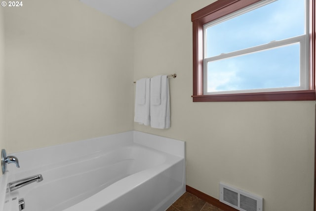 bathroom featuring a bathing tub and tile patterned flooring