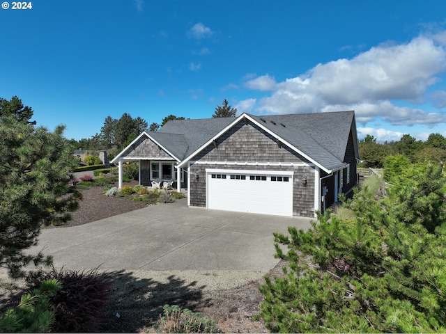 402 Diamond Ln, Gearhart, OR 97138 - craftsman house featuring a porch, driveway, a shingled roof, and a garage