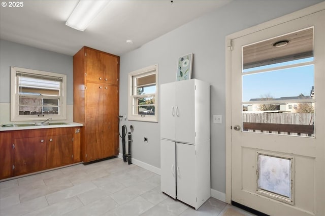 kitchen featuring sink and white fridge