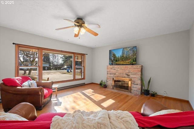 living room with light hardwood / wood-style flooring, a baseboard radiator, and ceiling fan