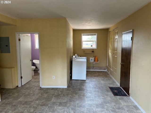 laundry area featuring electric panel and washing machine and dryer