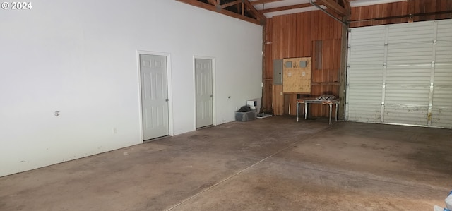 garage featuring wood walls and electric panel