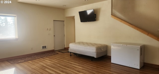 unfurnished room with hardwood / wood-style flooring