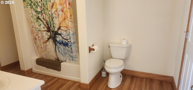 full bathroom featuring shower / bathtub combination with curtain, vanity, hardwood / wood-style floors, and toilet