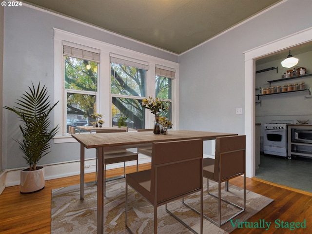 dining room with crown molding, dark hardwood / wood-style floors, and a healthy amount of sunlight